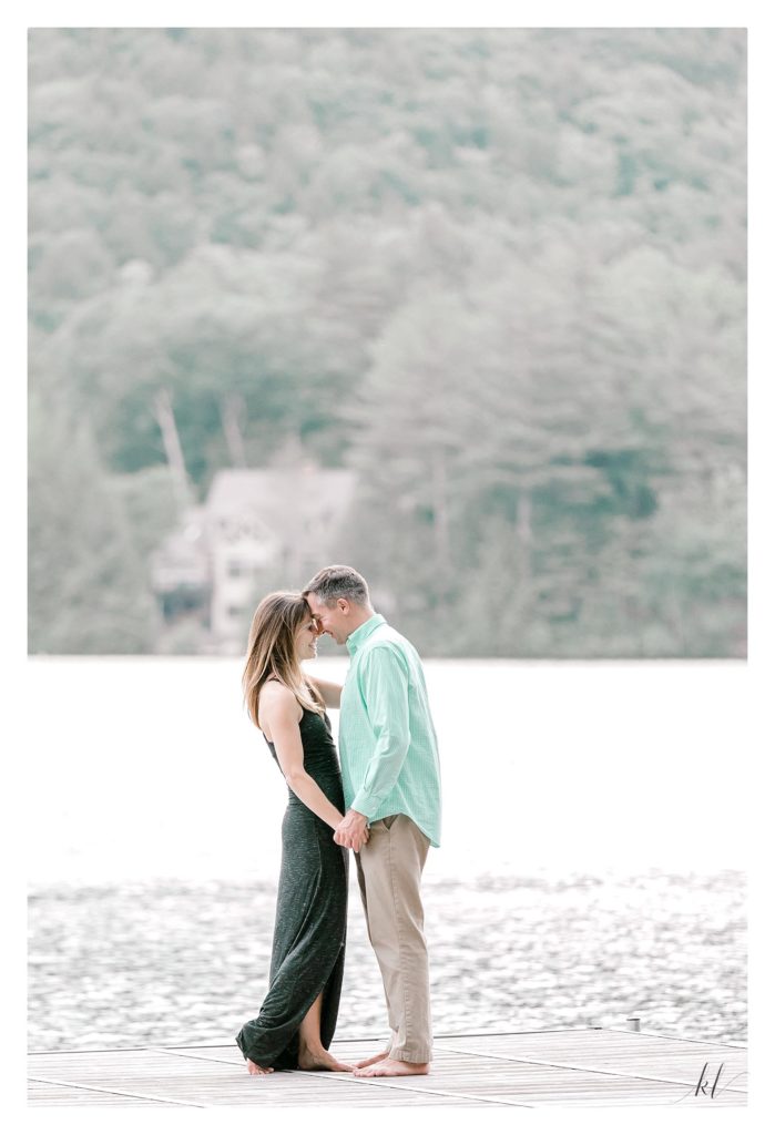 Light and Airy Candid photo of a man and woman holding hands on a dock during their Rustic Engagement Photos. 
