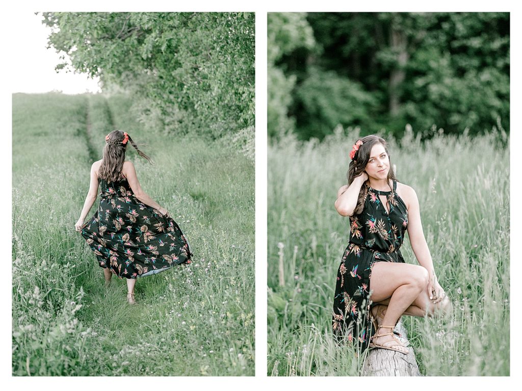 Bohemian Inspired Photoshoot showing a girl wearing a black flowered dress in a field with green grass. 