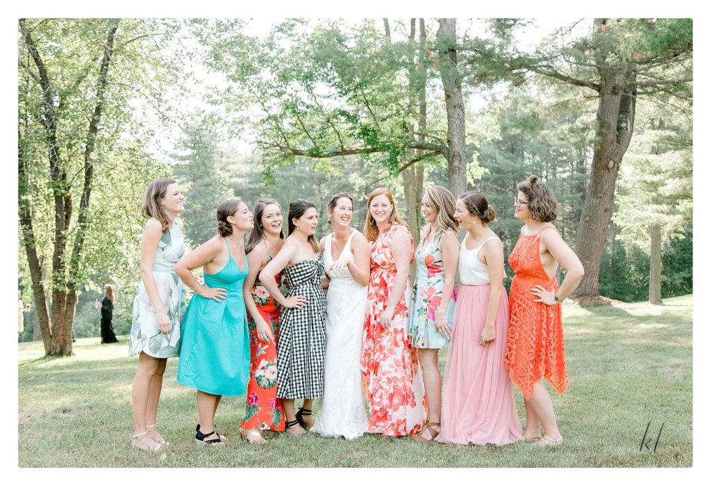 Fun group portrait of a bride and her college friends at a casually elegant backyard wedding. 