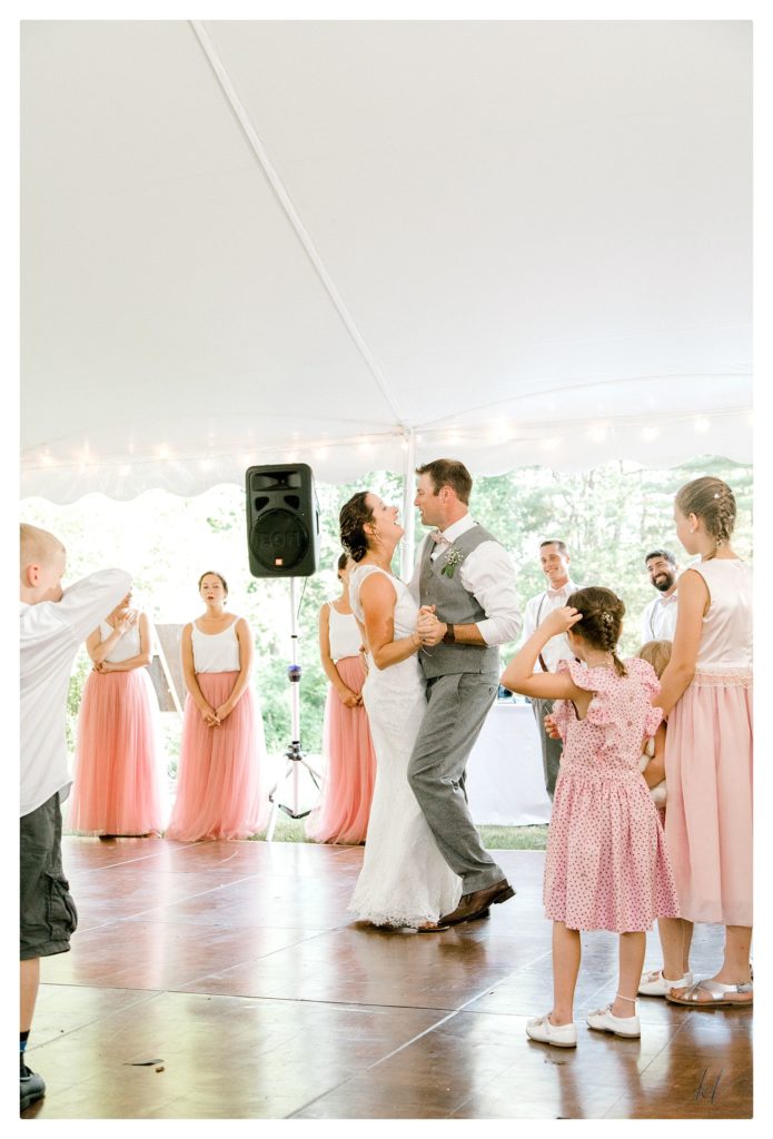 Bride and Groom dance and sing during their first dance at their casually elegant wedding reception. 