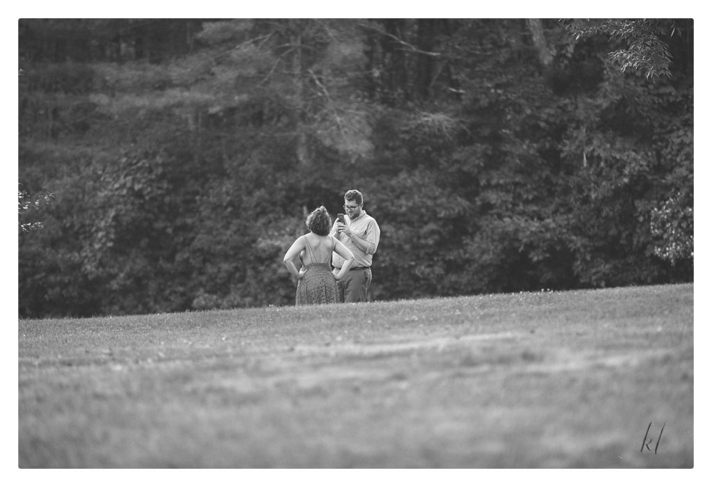 Black and White candid photo of a man and woman in a field. 