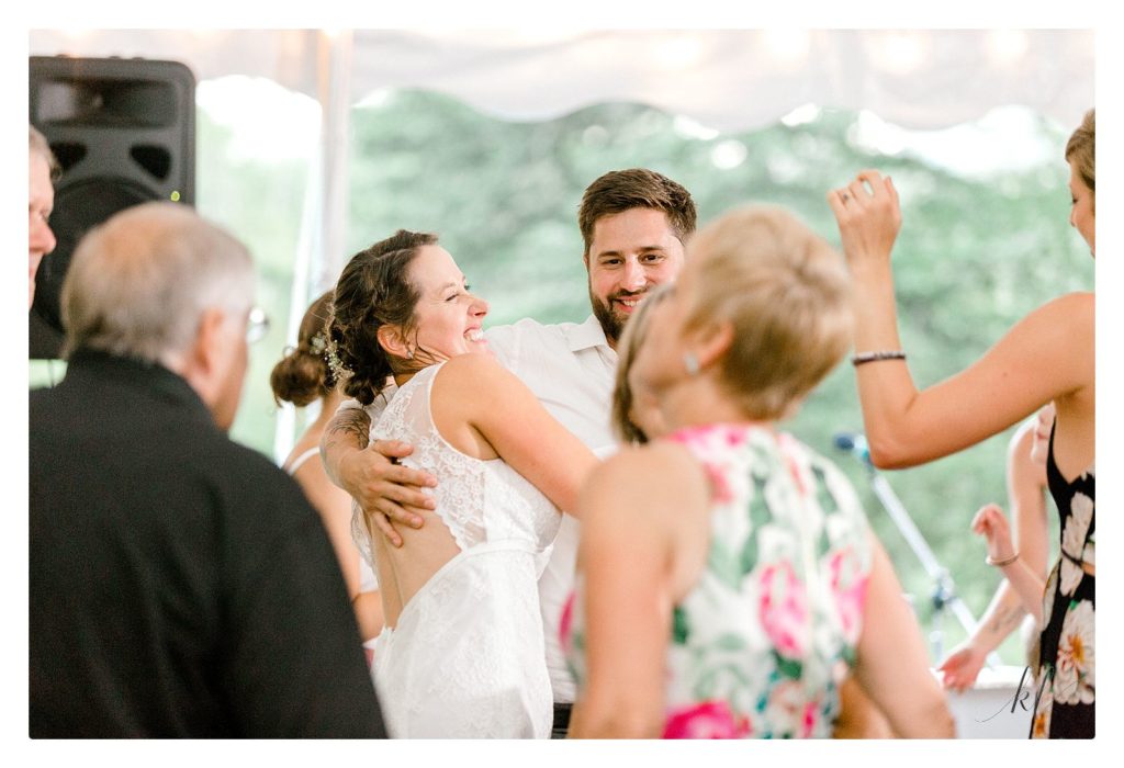 Candid photo of bride dancing during her wedding reception. 