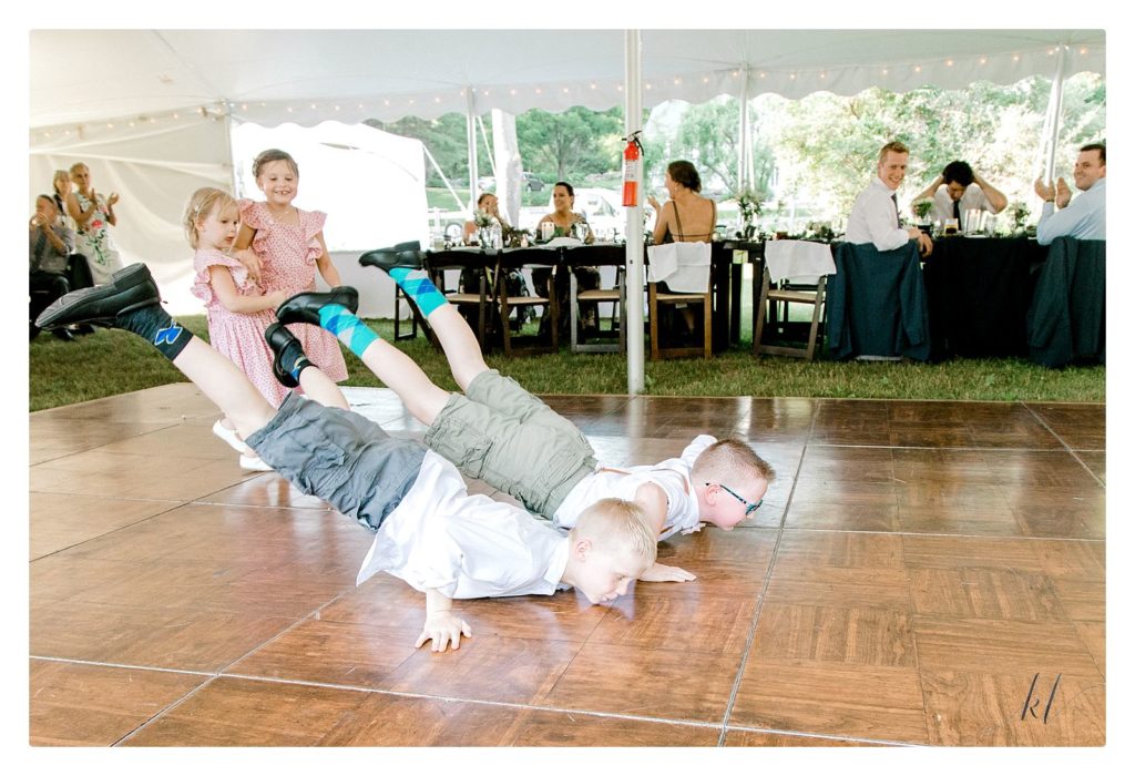 Ring Bearers make a fun entrance by dancing the "worm"