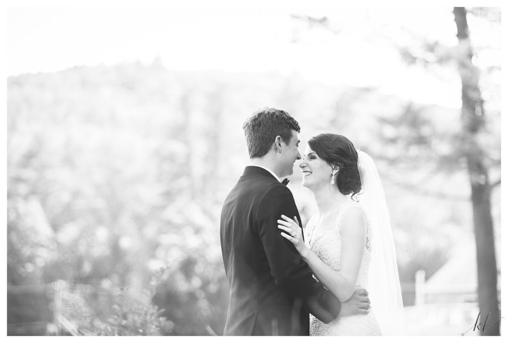 Black and White photo of a bride and groom laughing at their Keene Country Club summer wedding. 