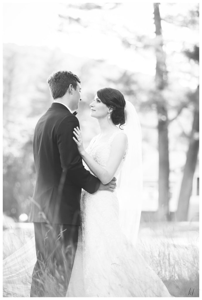 Candid and natural black and white photo of a bride and groom on their wedding day at the Keene Country Club. 