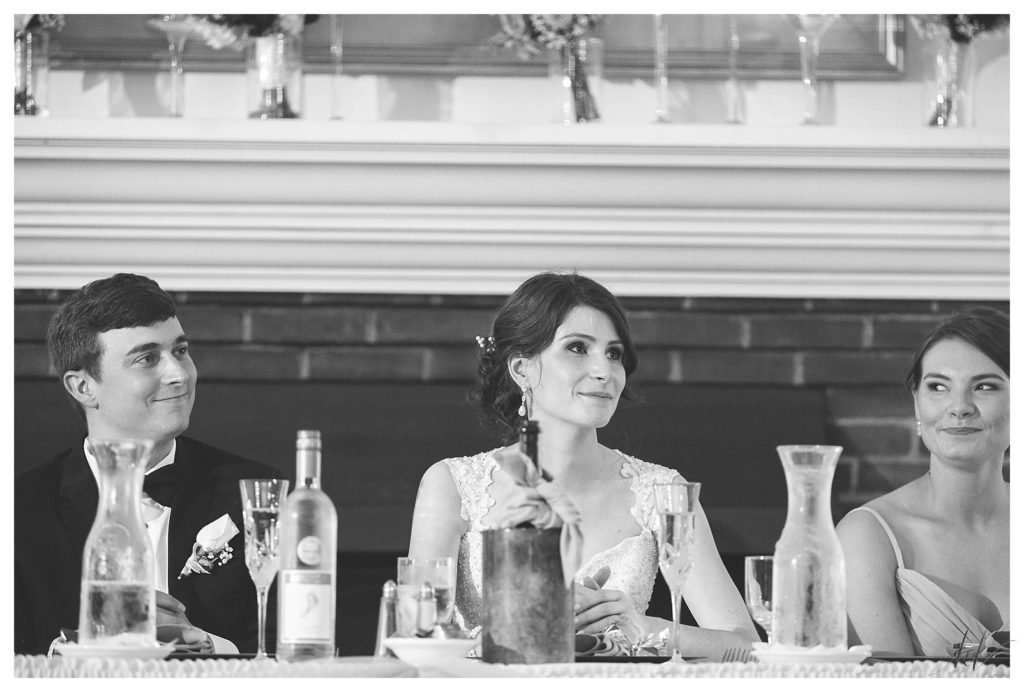 Daughter listens to her father give a speech at the Keene country club wedding. 