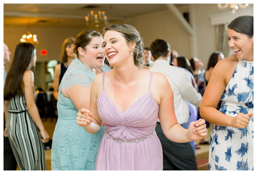Fun and Candid photo of a bridesmaid dancing at the Keene Country club wedding reception. 