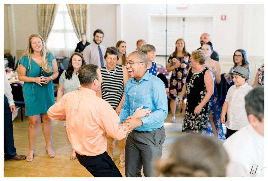 Guests dancing and having fun at the Keene Country club summer wedding reception. 