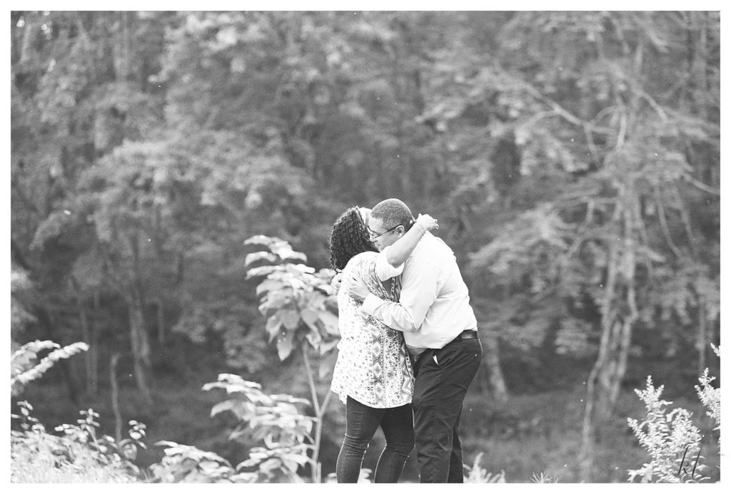 Black and White candid photo of a man and woman hugging