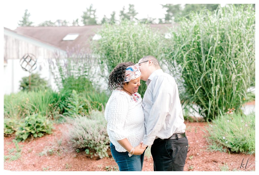Light and Airy candid photo of a man and woman laughing together at their Alpine Grove Engagement Session | Hollis NH - 