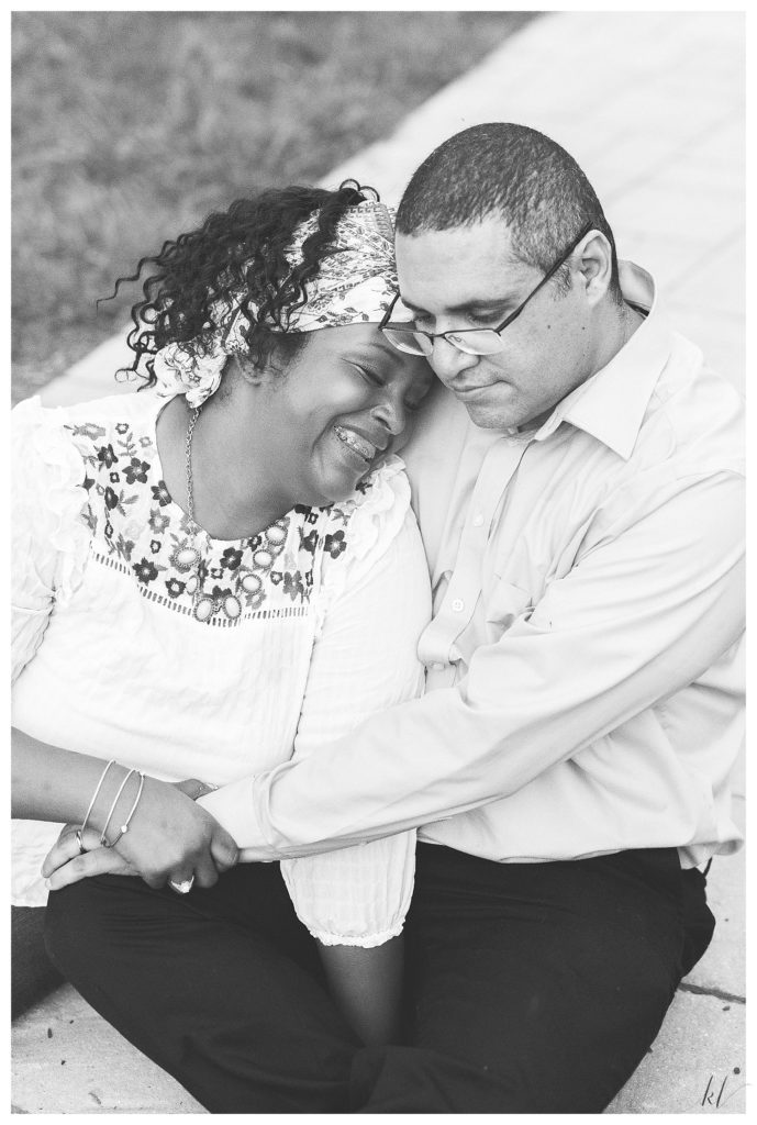 Black and White photo of a man and woman cuddling. 