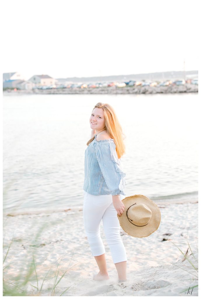 High school senior portrait of a girl wearing white capris and a blue shirt on Drakes Island in Wells Maine.   K. Lenox Photography