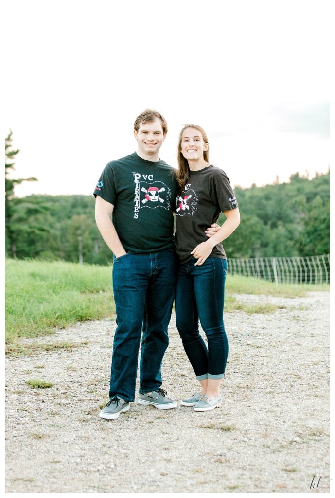 Posed portrait of a man and woman wearing High School Robotics Club t shirts because thats the club where they met. 