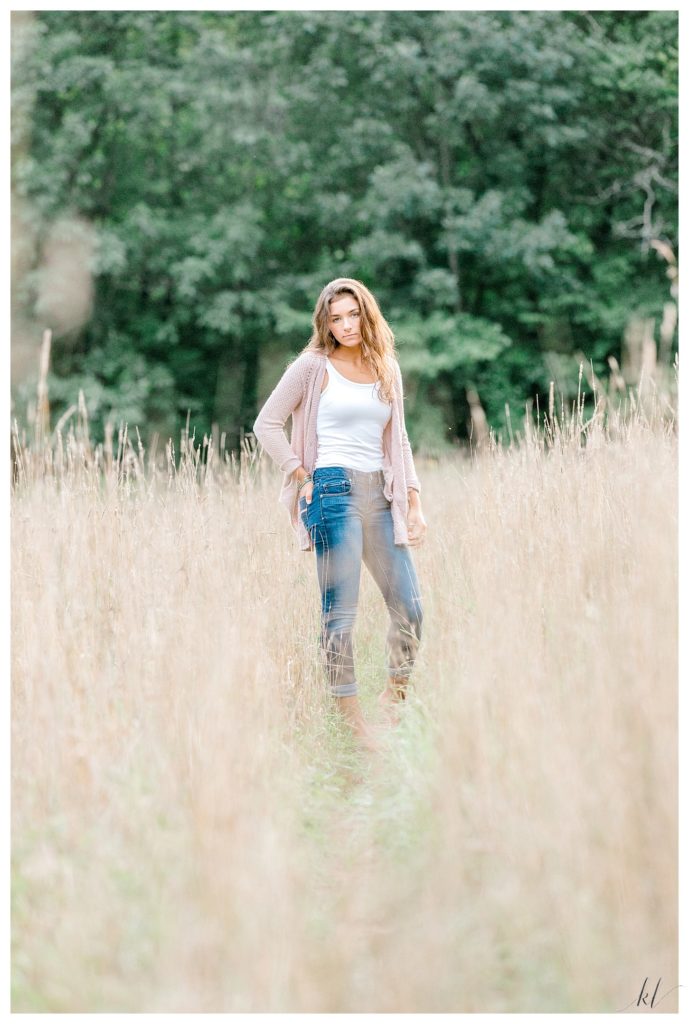 Light and Airy senior photo of a girl in a field of Wheatgrass taken by K. Lenox Photography. 