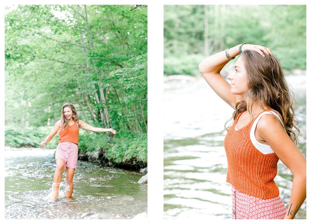 Girl wearing a red skirt and orange sweater/shirt plays in a river for her Light and Airy Senior Photos on Dort Road in Surry NH. 