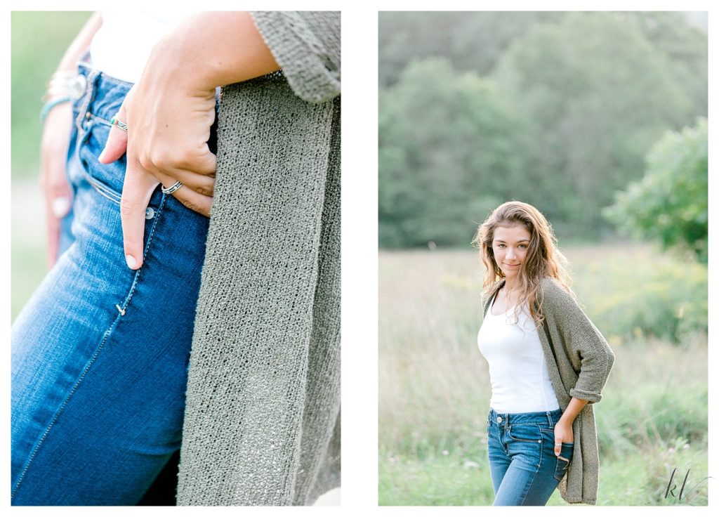 Girl wearing blue jeans, white tank and an olive green sweater for her senior portraits. 