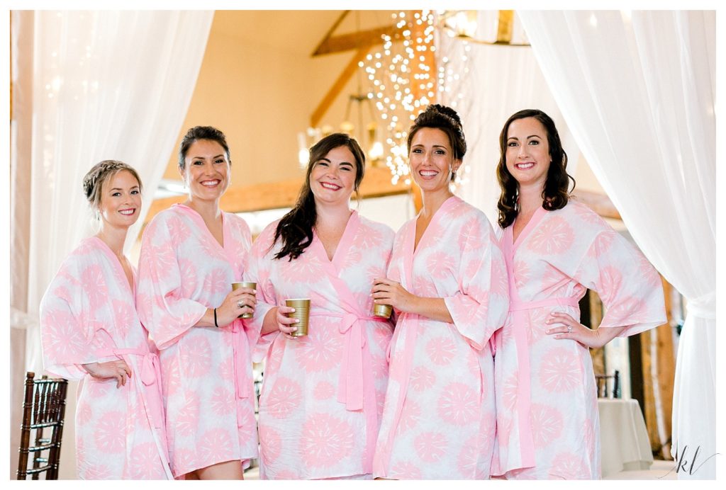 5 Bridesmaids pose for a portrait in their pink and white floral robes at the BVI