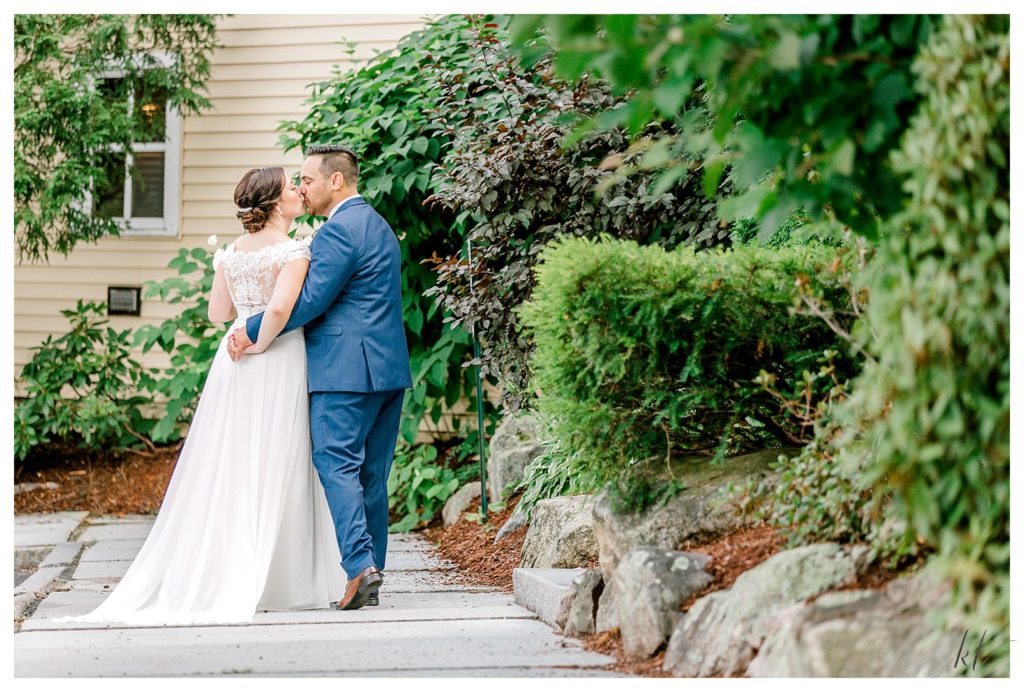 Bride and groom kissing at the Bedford Village Inn. 