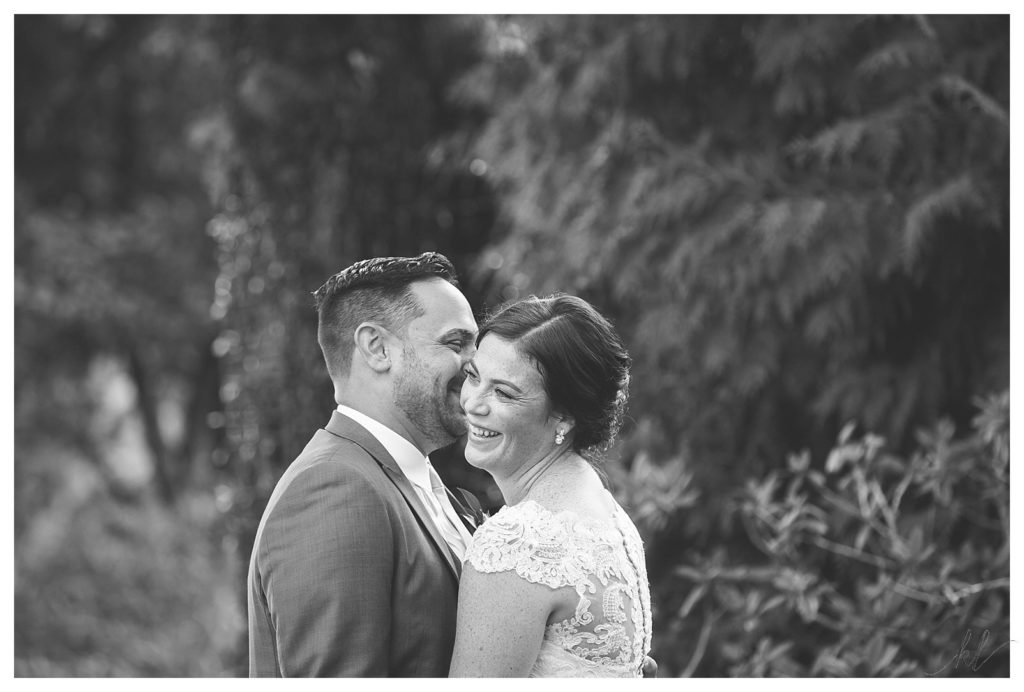 Candid and black and white photo of a bride and groom on their wedding day at the Bedford Village Inn. 