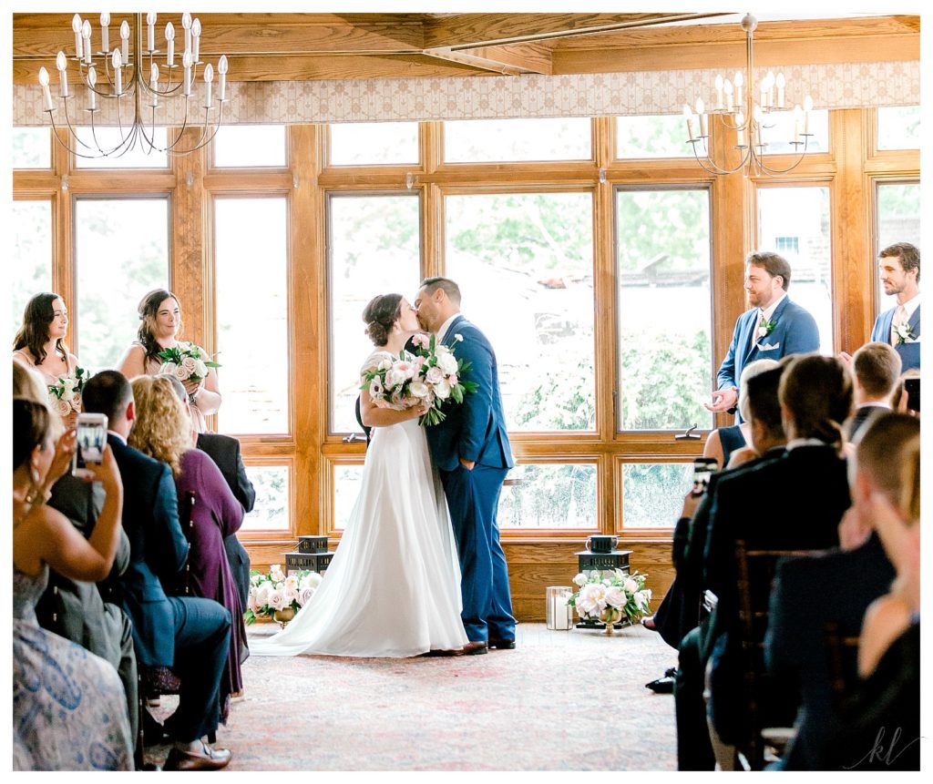 Indoor rainy wedding ceremony at the Bedford Village Inn. Bride and Groom Kissing just after the ceremony