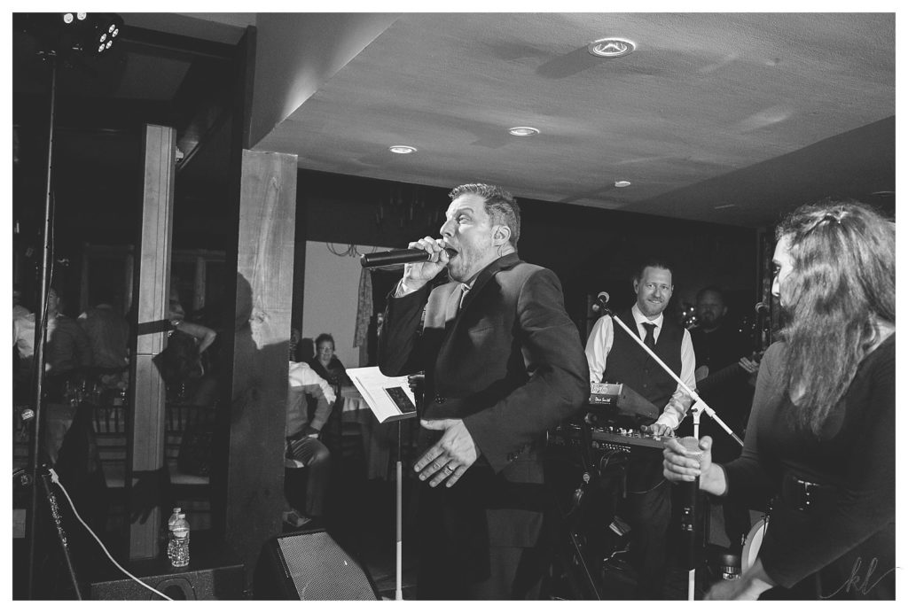 Lead singer from the Boston Band: Hot Mess sings at a wedding reception at the Bedford Village Inn