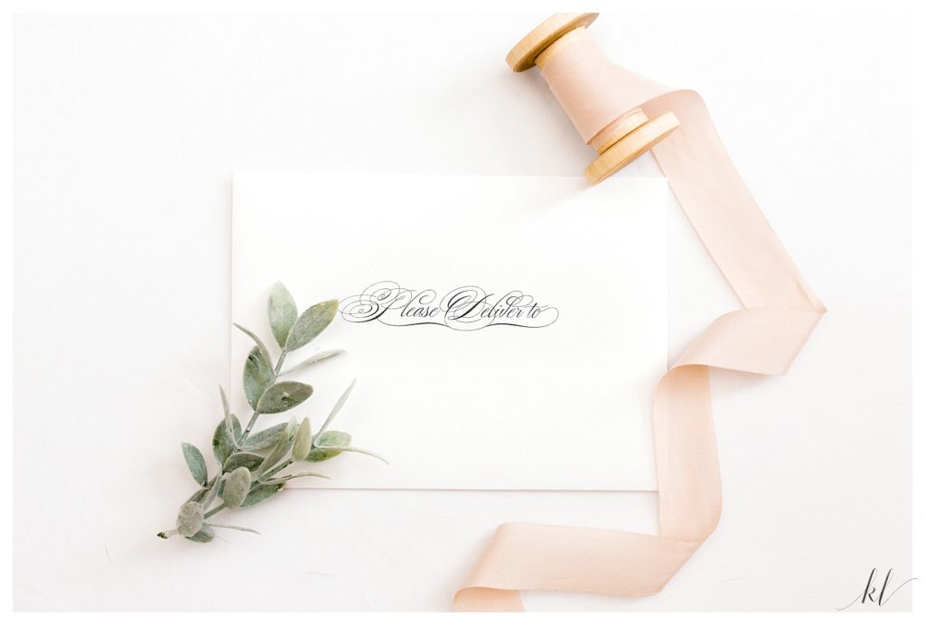 White Wedding Invitation Envelope with Pink Ribbon. 