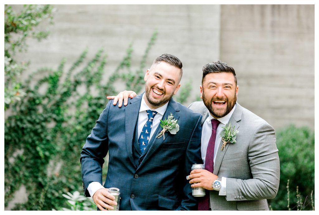 Candid portrait of a Groom and one of his groomsmen laughing and enjoying a drink. 