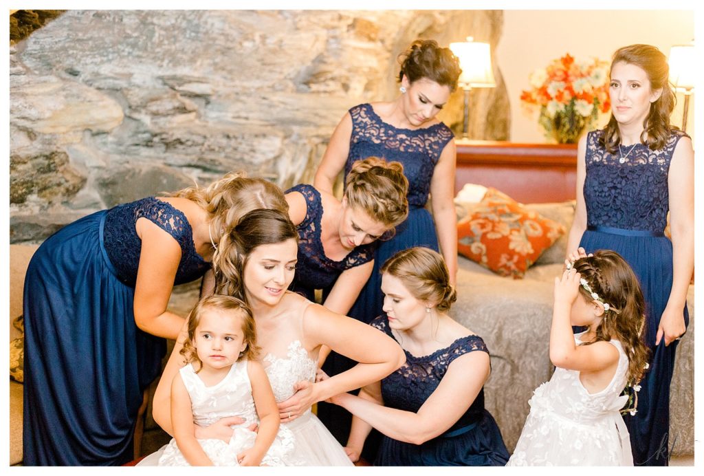 Bridesmaids wearing blue gowns assist the bride on her wedding day at the Common Man Inn and Restaurant in Claremont NH