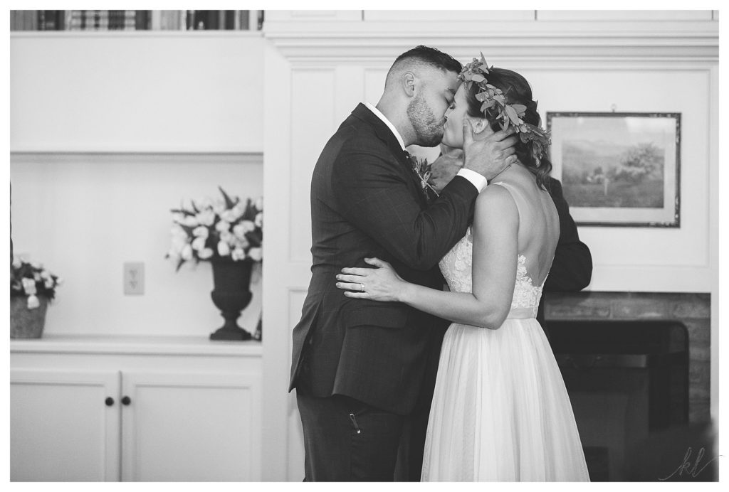 Black and White photo of a bride and groom's first kiss at the end of their wedding at the Common man in Claremont. 