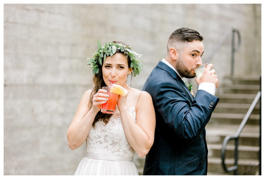 Bride and groom drink their alcoholic beverages during their portrait session after their wedding at the Common Man in Claremont. 