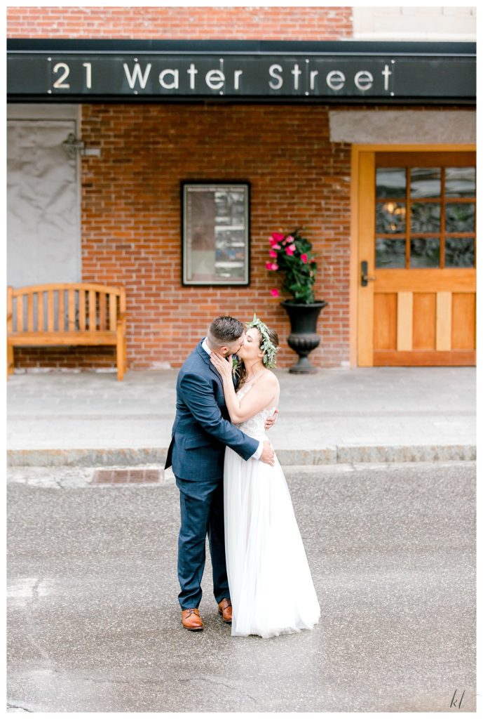 Bride and Groom kiss in front of 21 Water Street, Claremont NH. 