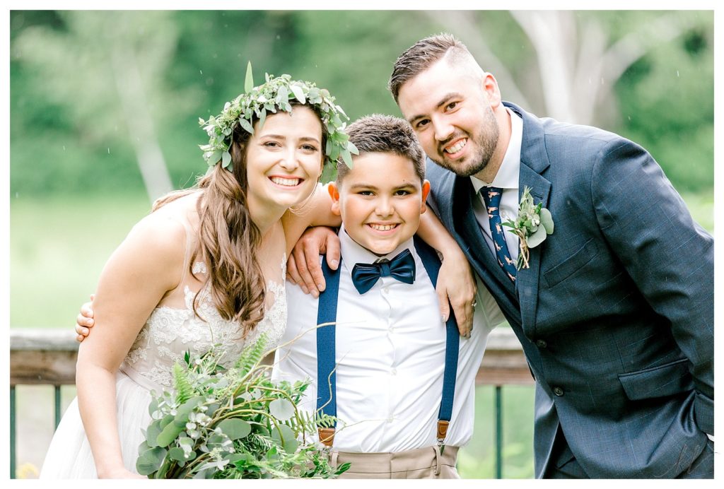 Bride wearing greenery crown with a groom and a ring bearer wearing a bow tie. 