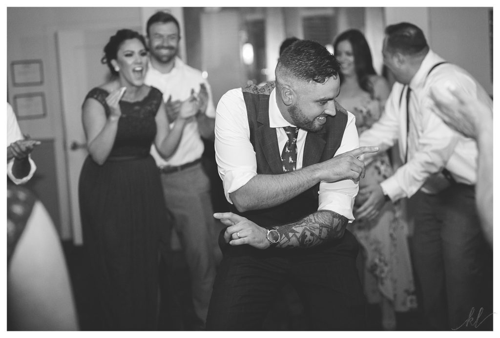 Black and White photo of a groom dancing during his reception for a Wedding at the common man in Claremont. 