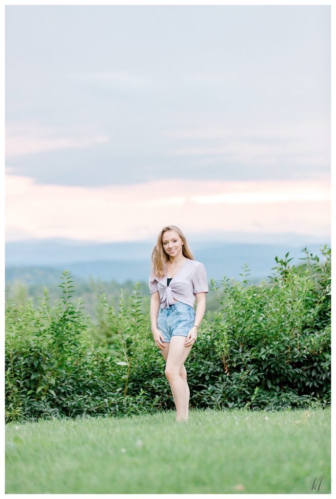 Senior portrait taken in West Chesterfield NH of a high school senior girl wearing jean shorts. 