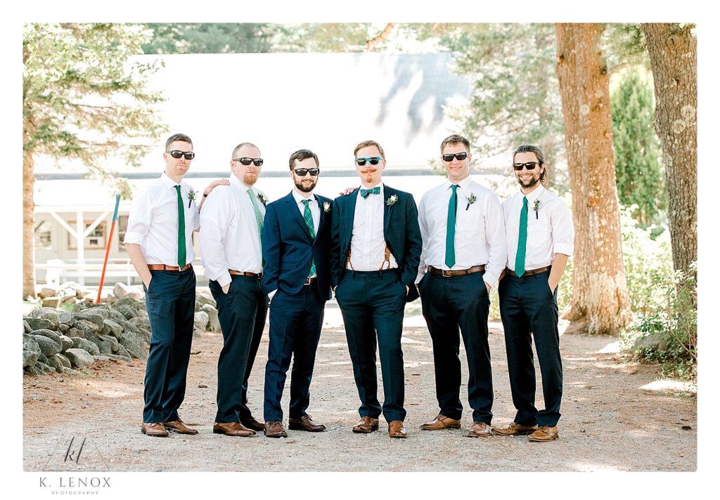 Groom with his groomsmen at Camp Lawrence, posing for a photo wearing sunglasses. 