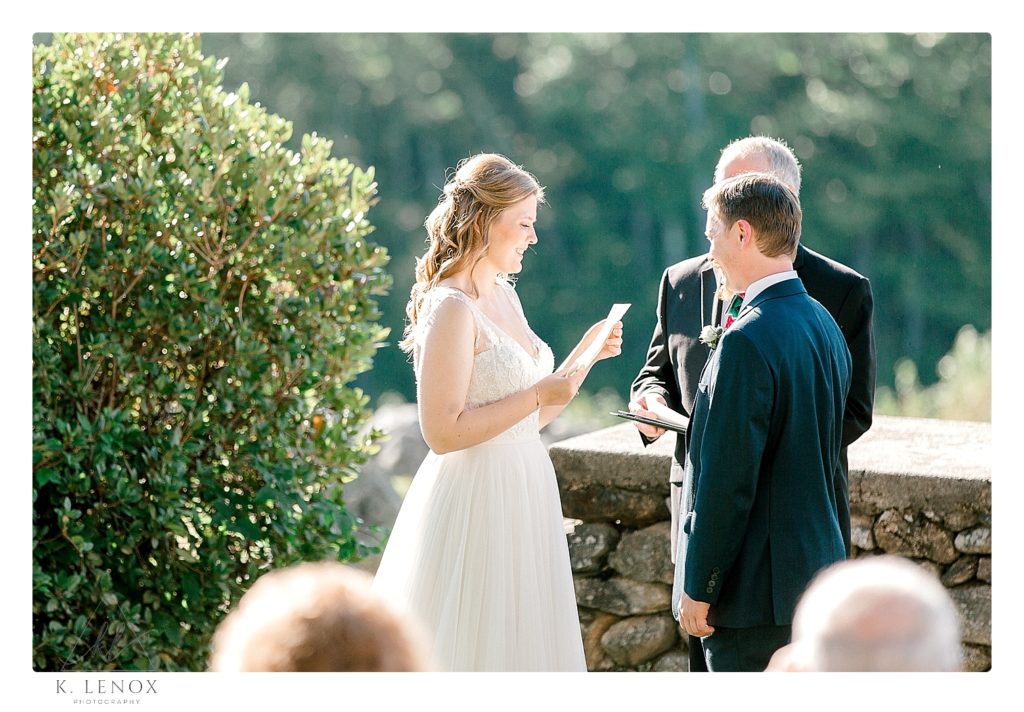 Bride Reads her vows to the groom during their camp wedding ceremony in Northern NH