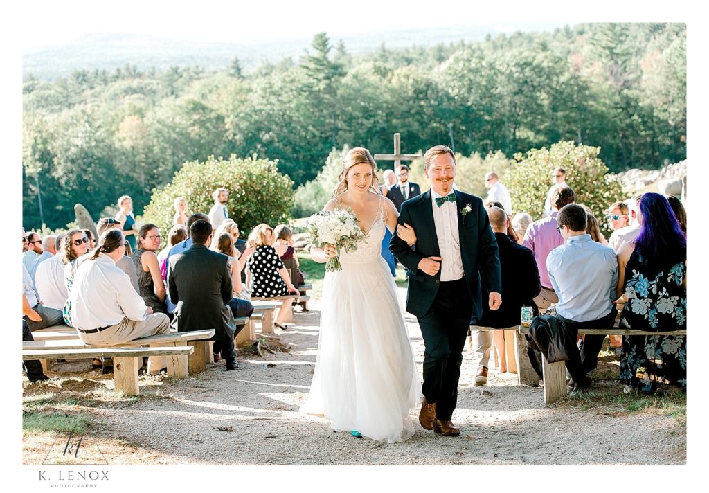Husband and Wife recess down the aisle after their wedding ceremony at the William Lawrence Camp