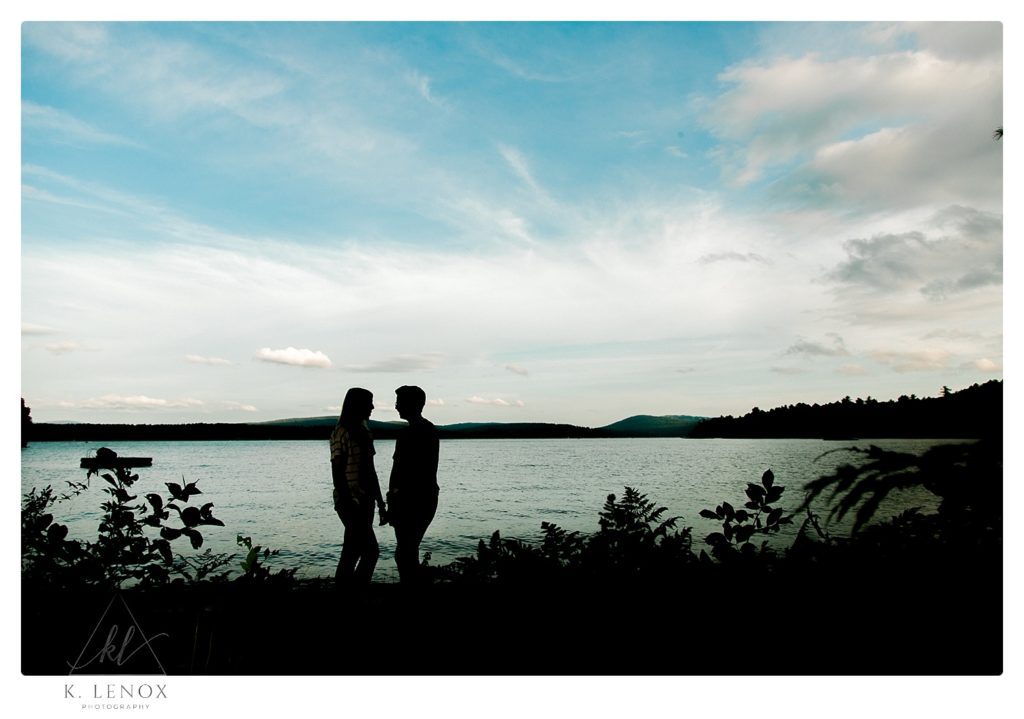 Silhouette photo of an engaged photo taken on the shore of Lake Sunapee in NH. 