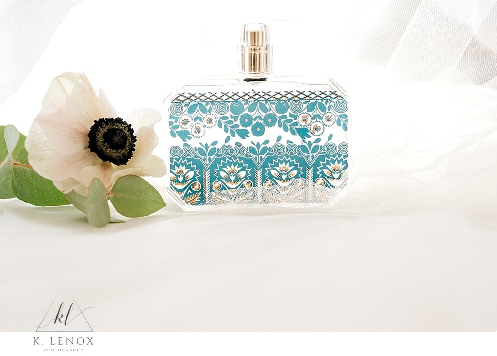 Perfume and a flower photographed for a Fall Wedding detail shot. 