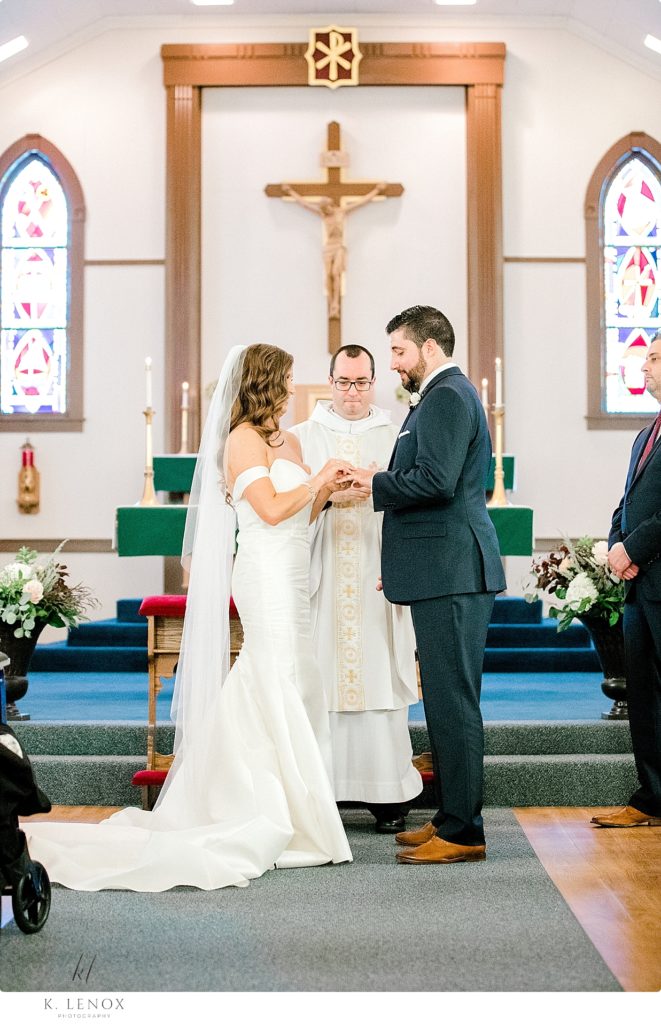 Exchanging of the rings during a catholic church ceremony. 