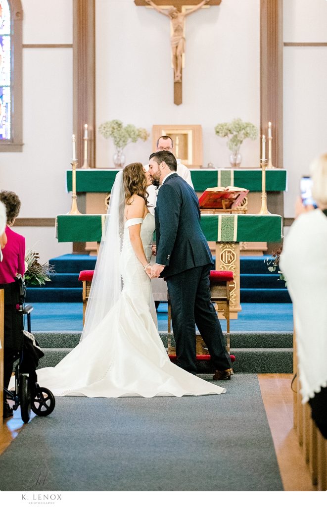 First Kiss as Man and Wife during a Catholic Wedding Ceremony