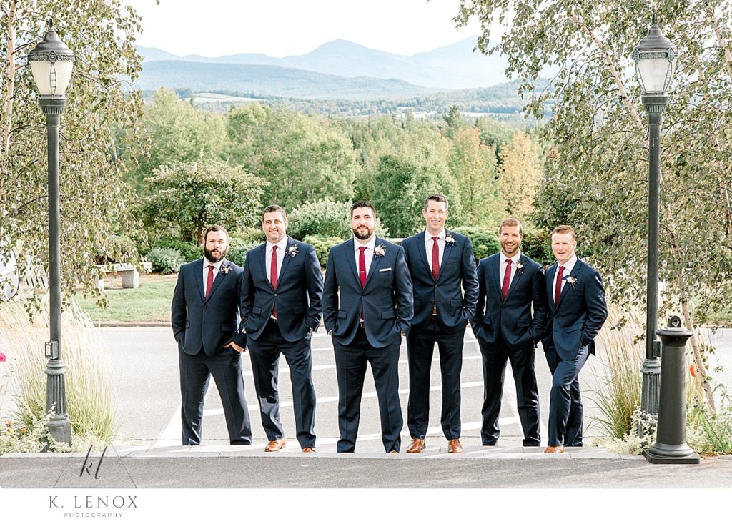Groomsmen posing for a photo on the steps in front of the Mountain View Grand. 