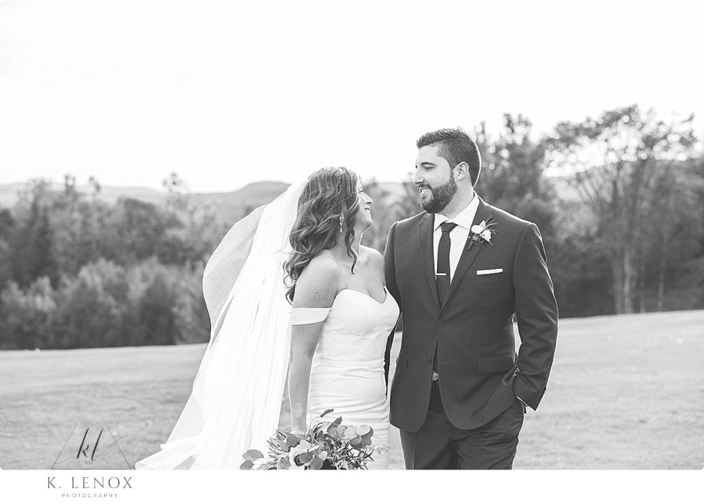 Black and White photo of a Bride and groom talking on their wedding day. 