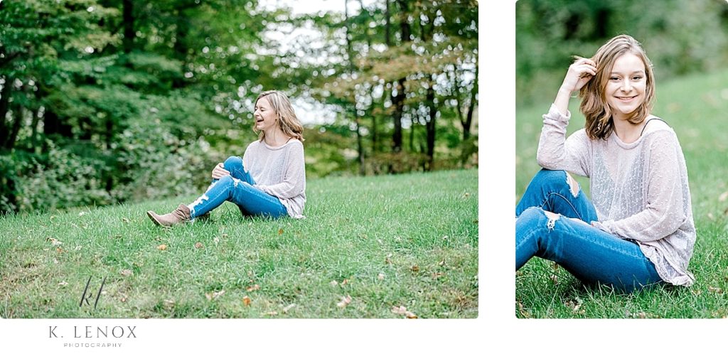 Light and Airy senior Photos of a girl sitting on green grass wearing blue jeans and a sheer sweater. 