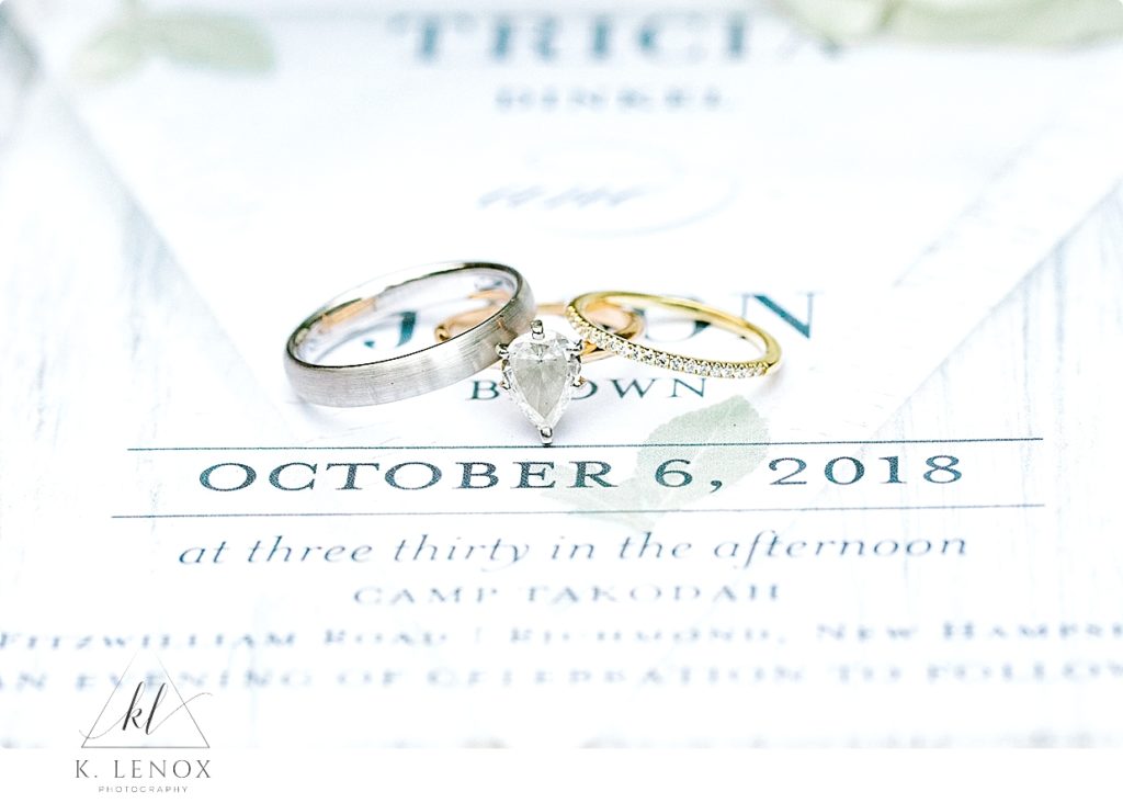 Set of wedding bands shown in White Gold, and yellow gold. White wedding invitation. 