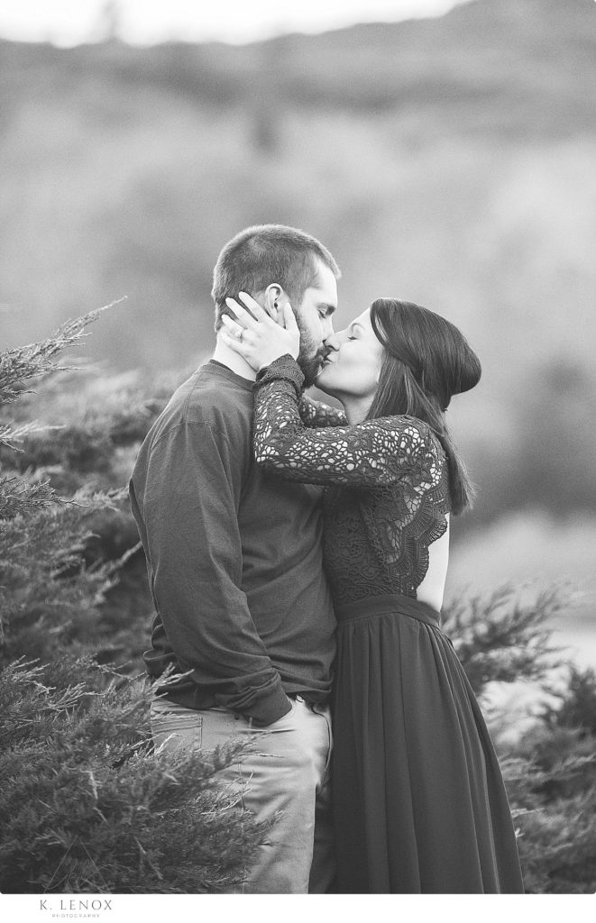 Black and White photo of a man and woman kissing during their engagement session. 
