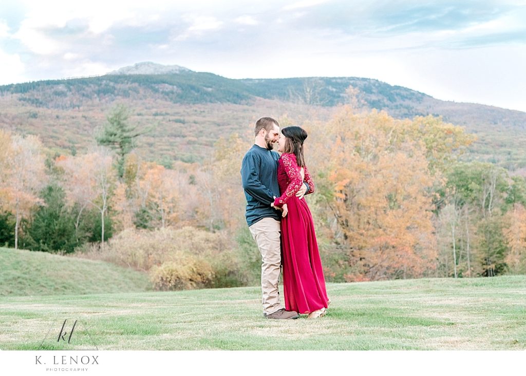 Man and Woman candidly hug and laugh during their fall Engagement Session at the Grand View Estate. 