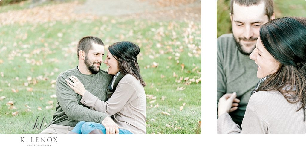Light and Airy photo of an engaged couple hugging and laughing on the ground surrounded by leaves. K. Lenox Photography
