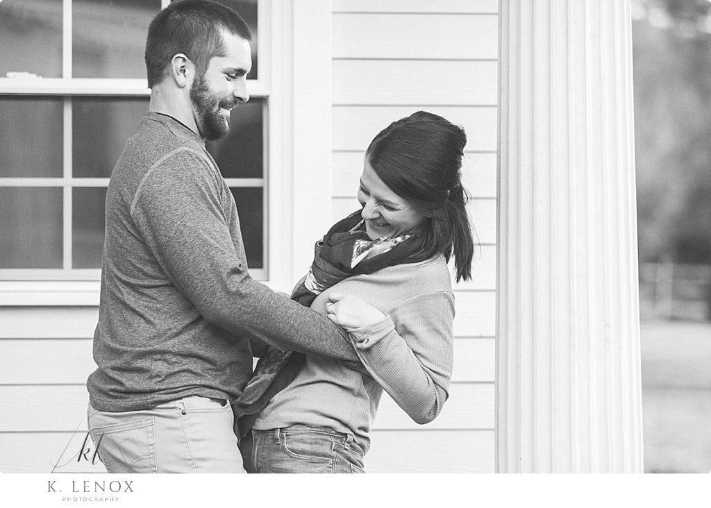 Candid Black and White photo of a man and woman laughing together during their engagement session at the Grand View Estate. 