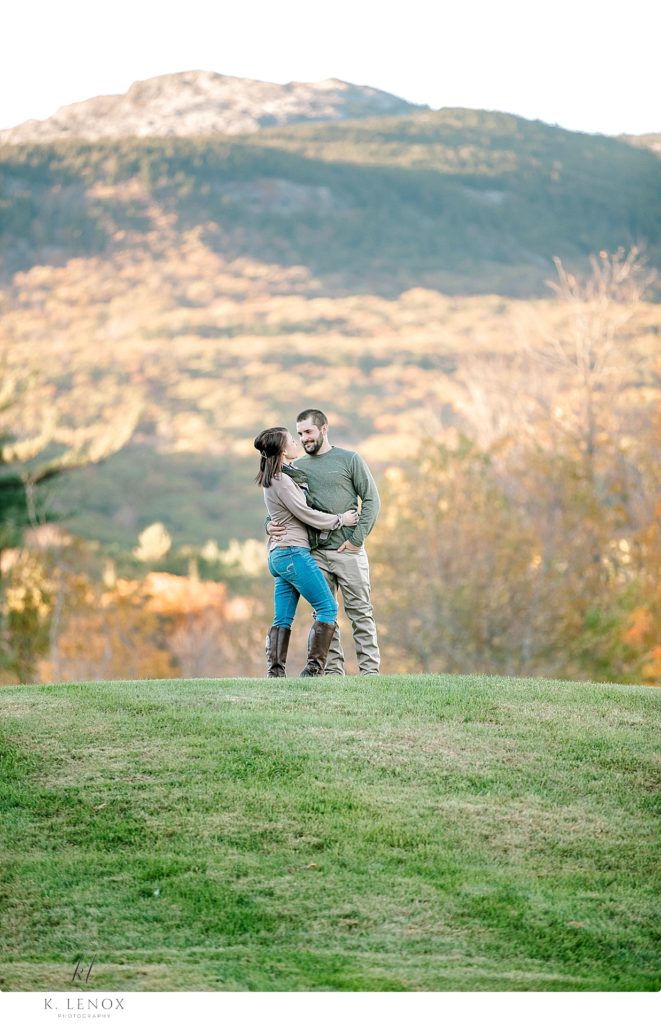Engagement Session at the Grand View Estate- Light and Airy photo of a man and woman showing Mount Monadnock in the back ground. 